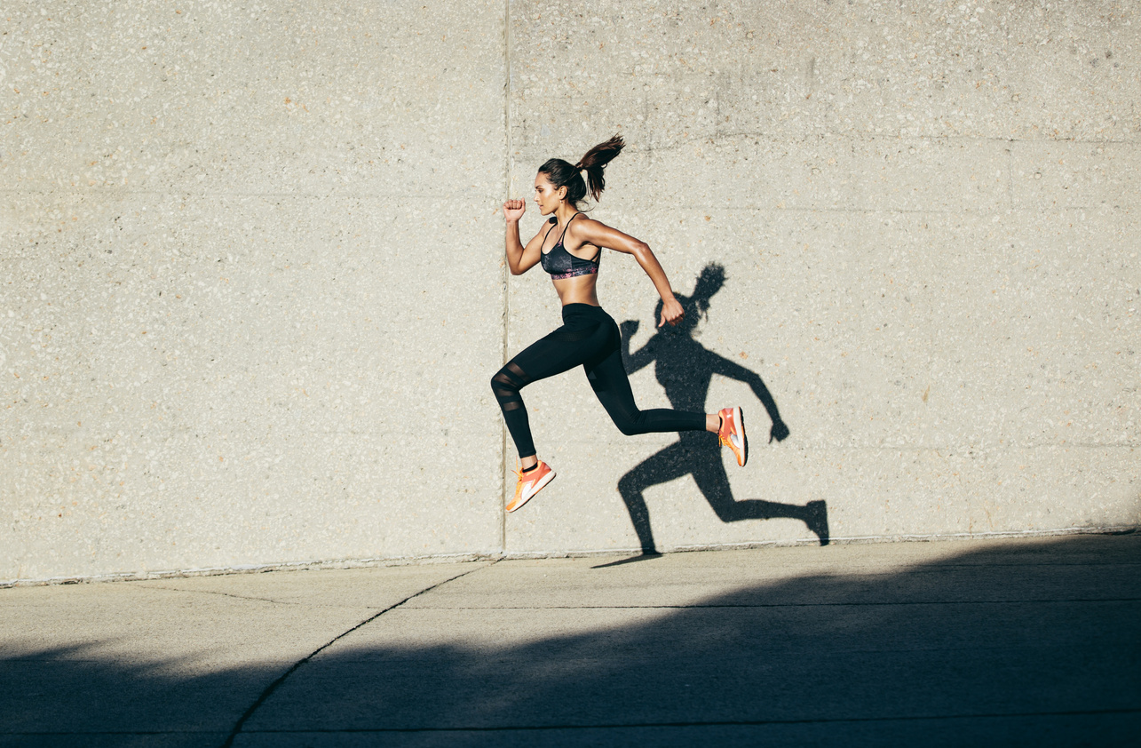 Sportswoman Running and Exercising Outdoors