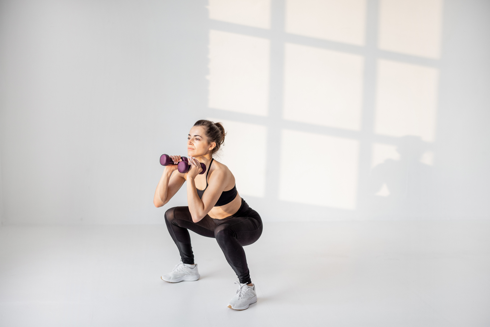 Fit Woman Using Dumbbells to Workout